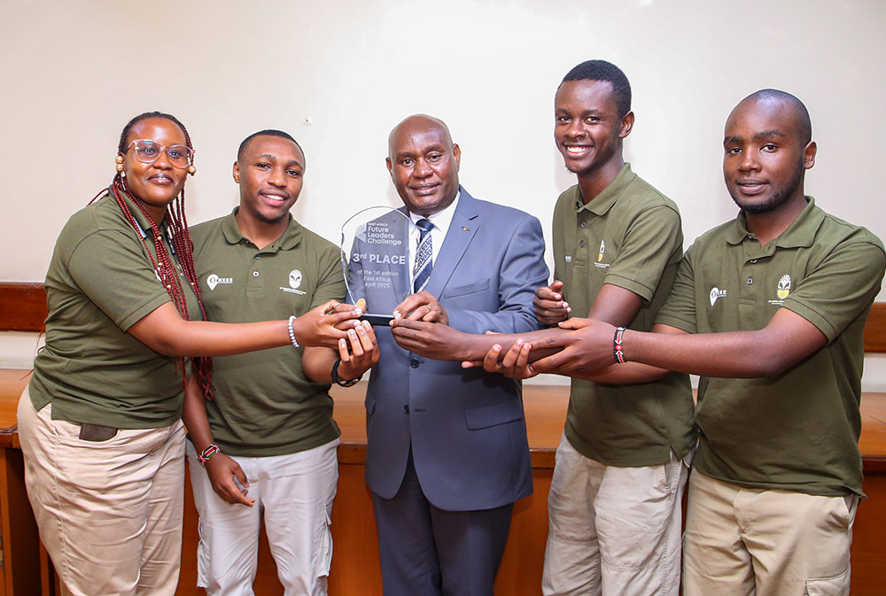 Tourism Tech’ Project developers present the trophy they won during East Africa Future Leaders Challenge to the VC Prof. Benedict Mutua