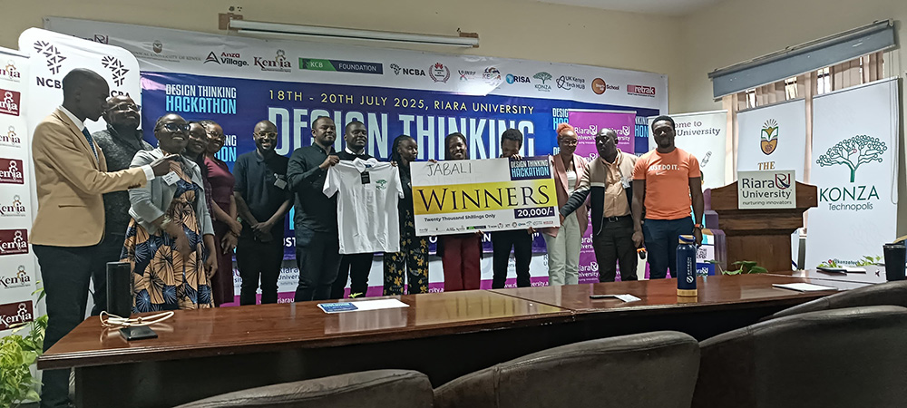 The winning team from 2nd Edition, Design Thinking Hackathon displaying a dummy Cheque at the climax of a 3-day competition at Riara University. 