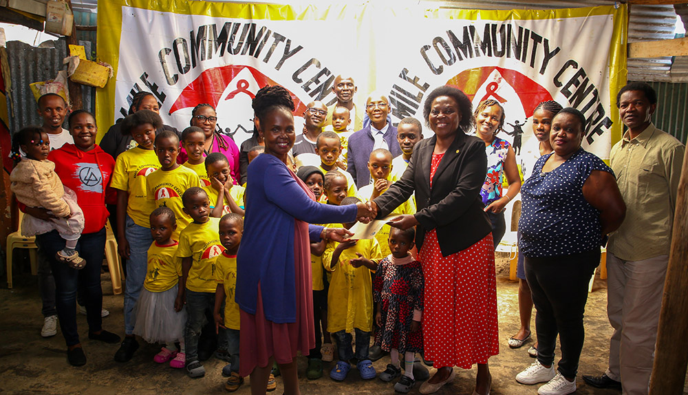 Members of the staff from TU-K led by Director, Community Outreach Linkages and Partnerships Dr. Judith Waswa in a group picture with Smile Community Centre Founder Margaret Nekesa, staff and children when they visited the centr
