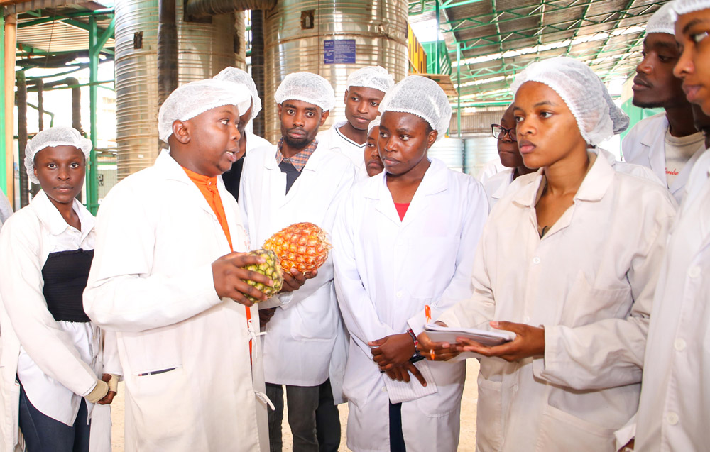 A member of staff at Kevian Kenya Limited, Thika, explains the process of juice production and packaging to TU-K students. 