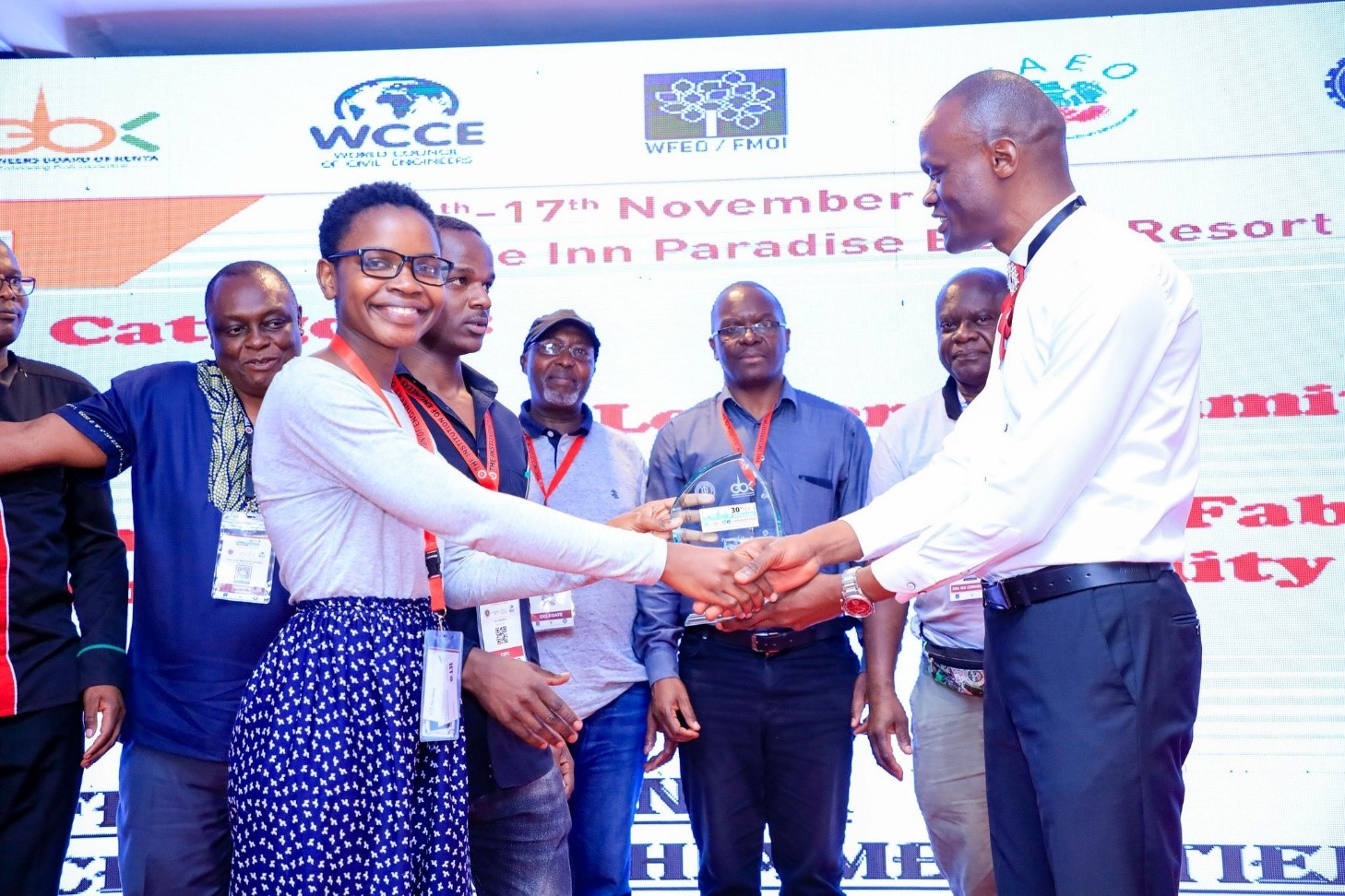 Cecilia Otieno receiving 1st Prize trophy from President IEK – flanked by TUK staff and students receives the prize she and Felix Mazinza won