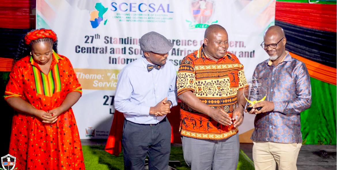 Prof. Tom Kwanya (right) receives an award in the category of Knowledge Creation and Sharing for his outstanding contribution to the generation, organisation, dissemination, and application of knowledge within the 