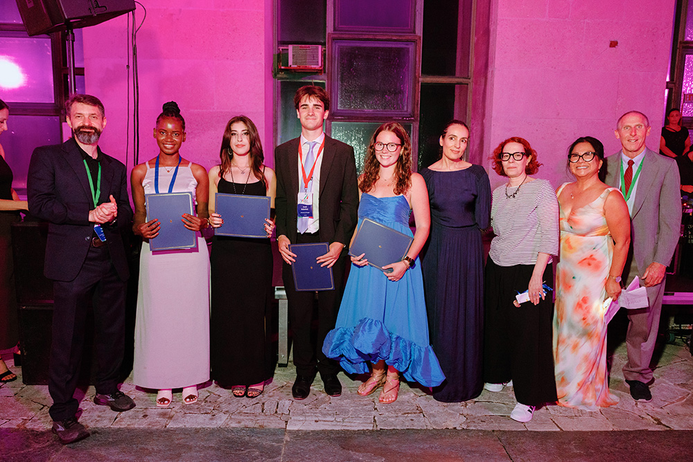 Veronica Okola (second left) with X-Culture Founder Prof. Vasyl Taras (left) and team mates and staff from X-Culture during the award ceremony.